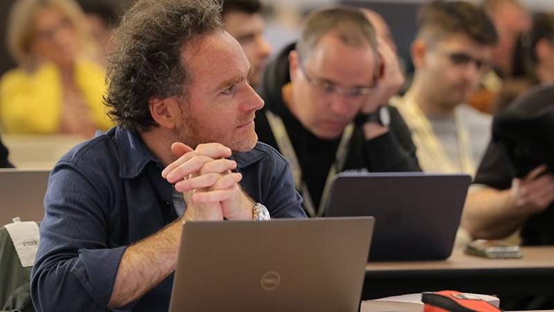 A picture of event attendees listening in on a presentation